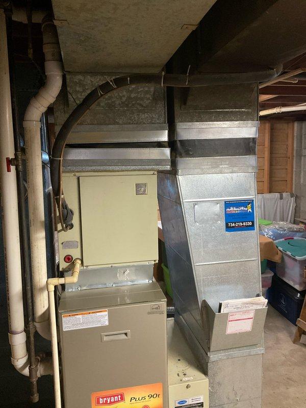 Conducted on-site assessment of existing Bryant Plus 90t furnace and connected ductwork system in residential basement utility area. Evaluated current HVAC equipment configuration, ductwork condition, and installation layout to provide comprehensive replacement estimate options. Documented equipment specifications, spatial constraints, and existing infrastructure including PVC venting, electrical connections, and metal ductwork assembly for accurate system replacement planning.