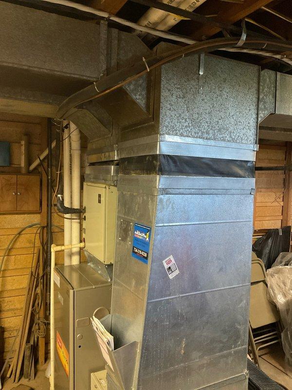 Conducted on-site assessment of existing Bryant Plus 90t furnace and connected ductwork system in residential basement utility area. Evaluated current HVAC equipment configuration, ductwork condition, and installation layout to provide comprehensive replacement estimate options. Documented equipment specifications, spatial constraints, and existing infrastructure including PVC venting, electrical connections, and metal ductwork assembly for accurate system replacement planning.