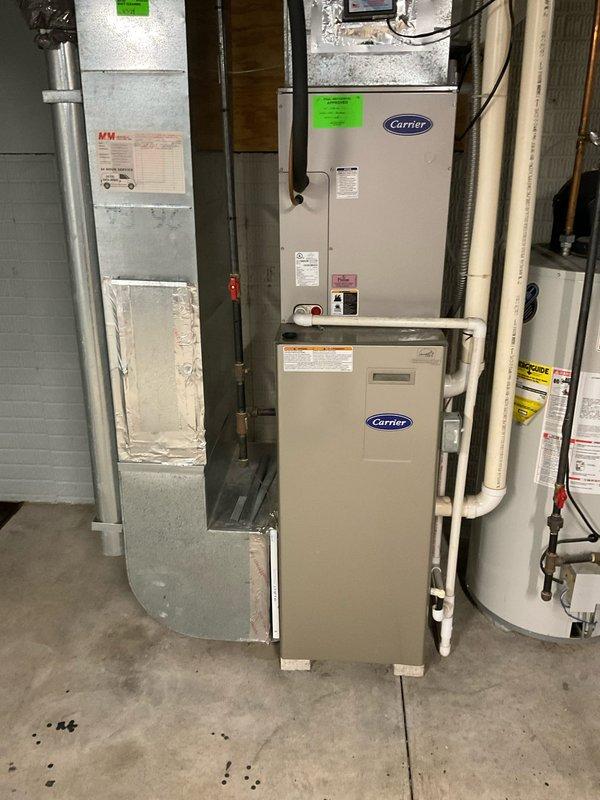 Provided comprehensive full system replacement estimate for residential HVAC equipment including existing Carrier furnace, air handler, and associated components in basement mechanical room. Documented current system configuration with 12 SEER rating and assessed ductwork, refrigerant lines, condensate drainage, and electrical connections for replacement planning.