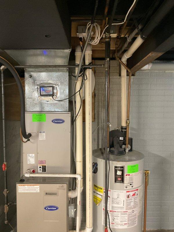 Provided comprehensive full system replacement estimate for residential HVAC equipment including existing Carrier furnace, air handler, and associated components in basement mechanical room. Documented current system configuration with 12 SEER rating and assessed ductwork, refrigerant lines, condensate drainage, and electrical connections for replacement planning.