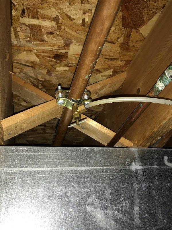 Completed Club AC10-2 preventive maintenance agreement visit on residential air conditioning system. Performed comprehensive inspection of evaporator coil assembly, verifying proper operation and condition of finned tube heat exchanger with aluminum fins. Documented attic-mounted equipment including refrigerant line routing and structural mounting configuration. Coil showed normal condensation and operational wear patterns consistent with regular use. All system components inspected and photographed for maintenance records.
