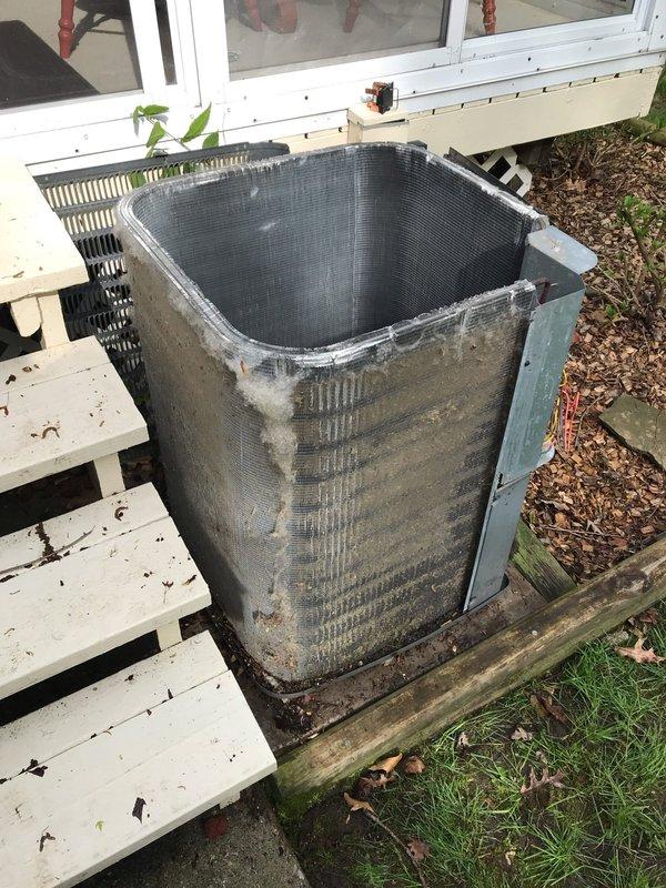 Completed scheduled maintenance visit for air conditioning system. Performed inspection of outdoor condensing unit, which showed heavy accumulation of dirt and debris on exterior coil surfaces. Accessed electrical compartment to verify proper operation of capacitor, contactors, and control wiring connections. All electrical components functioning within normal parameters despite visible age-related wear on interior surfaces.