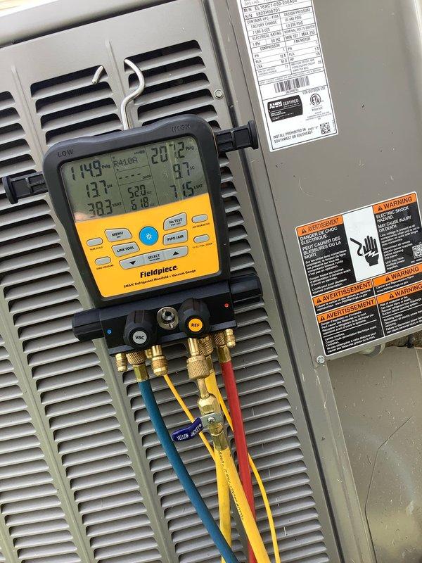 Completed Club AC8-12 preventive maintenance agreement visit on residential air conditioning system. Performed comprehensive system diagnostics using Fieldpiece SC440 multimeter to verify electrical parameters, obtaining readings of 743 on control circuits. Connected Fieldpiece manifold gauge set with three-hose configuration to measure system pressures and temperatures, recording superheat and subcooling values including temperatures of 148°F, 207°F, and 137°F to confirm proper refrigerant charge and system operation. Inspected unit housing, electrical connections including wire-nutted control wiring, and manufacturer specification labels. All safety warning labels present and legible. System operating within normal parameters with no deficiencies noted. Unit left in proper working condition.