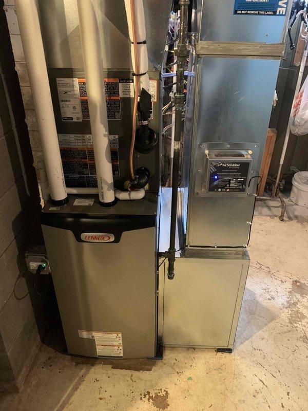 Completed warranty installation of air purifier unit on existing Lennox HVAC system. Unit was inadvertently omitted from original installation work order and has now been properly integrated into the system with appropriate electrical connections and ductwork configuration.