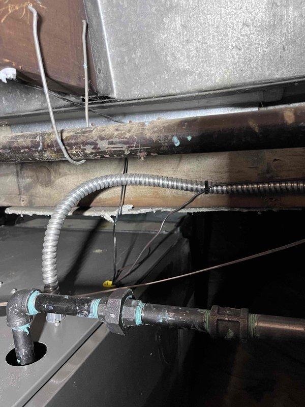 # HVAC Complete System Installation

Successfully completed a full HVAC system installation including new furnace and associated ductwork in basement mechanical space. Installed modern forced-air heating unit with proper venting configuration, utilizing dual PVC intake and exhaust pipes with appropriate support brackets and elbow fittings. Connected unit to existing ductwork infrastructure with metal duct transitions at upper portion of installation. Secured all electrical connections using flexible metal conduit, properly fastened and routed to unit. Ensured all manufacturer specification labels and safety warnings remain visible and accessible on furnace front panel. Installation includes proper clearances from wooden framing and structural elements per code requirements. All piping connections secured with appropriate fasteners and support hardware. System positioned on concrete floor with adequate access for future maintenance and service. Installation financed through approved fin
