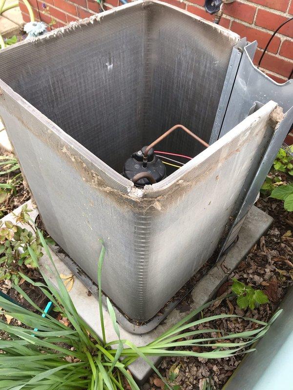Completed scheduled AC maintenance tune-up on outdoor condenser unit positioned against brick wall. Performed comprehensive system inspection, cleaned condenser coils and exterior surfaces removing accumulated dirt and grime, checked refrigerant lines and connections, verified compressor operation, and documented equipment condition with photos. Unit operational and ready for cooling season.