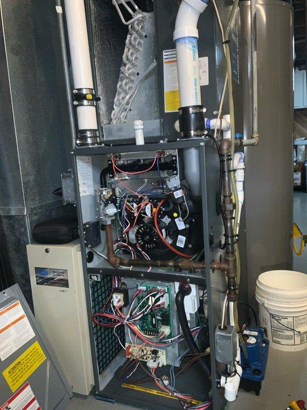 Completed Club AC10-2 preventive maintenance agreement visit on residential HVAC system. Performed comprehensive inspection of furnace unit, including blower motor assembly and squirrel cage fan. Documented equipment condition with photos showing moisture patterns on blower housing exterior, though motor and electrical connections appeared operational. Verified proper operation of internal components including circuit boards, gas valves, control modules, and wiring harnesses. Inspected PVC venting and condensate drainage systems for proper installation and function. All electrical connections tested and found secure. System operating within normal parameters at time of service completion.