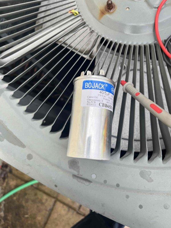 Completed scheduled air conditioner maintenance visit during afternoon service window. Performed comprehensive AC tune-up including system diagnostics and electrical testing using clamp meter, which recorded amperage readings of 523. Inspected and serviced condenser unit components, including examination of BOJACK brand dual-run capacitor (40/5µF CBB65 model) mounted on fan assembly. Verified proper electrical connections, assessed capacitor functionality, and confirmed condenser fan motor operation. All components found operating within normal parameters, and system ready for cooling season operation.