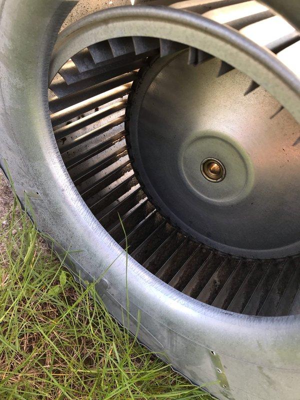 Responded to no heat call on 10+ year old HVAC system located in crawl space. Upon inspection, determined blower assembly was not operating correctly due to accumulated debris and wear. Removed blower wheel from unit housing, documented condition showing significant dust and dirt buildup on blades and internal components. Presented repair options to restore proper system operation.