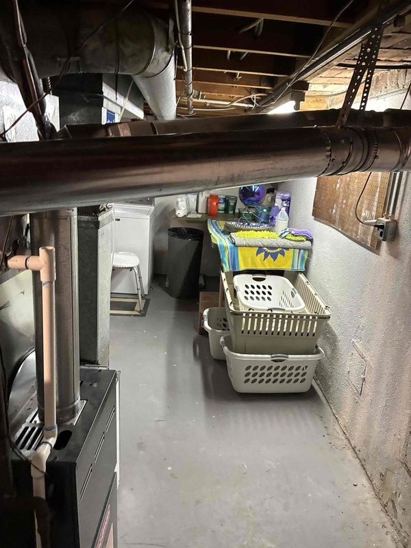 Completed installation of water heater in basement utility area. Unit positioned and secured in mechanical room with proper clearances maintained from surrounding storage and HVAC ductwork. All connections made to existing plumbing infrastructure, system tested and verified operational upon completion.