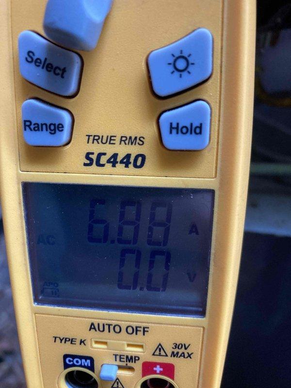 Performed preventive maintenance tune-up on HVAC system. Tested electrical components using digital multimeter, measuring current draw at 6.76 amps and verifying proper voltage readings. Inspected and tested capacitor, confirming capacitance reading of 2.498 microfarads on 25µF rated component, indicating potential degradation requiring monitoring or replacement. All measurements documented for service records.