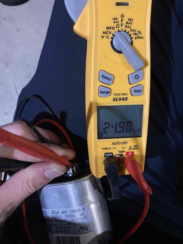 Performed preventive maintenance tune-up on HVAC system. Tested electrical components using digital multimeter, measuring current draw at 6.76 amps and verifying proper voltage readings. Inspected and tested capacitor, confirming capacitance reading of 2.498 microfarads on 25µF rated component, indicating potential degradation requiring monitoring or replacement. All measurements documented for service records.