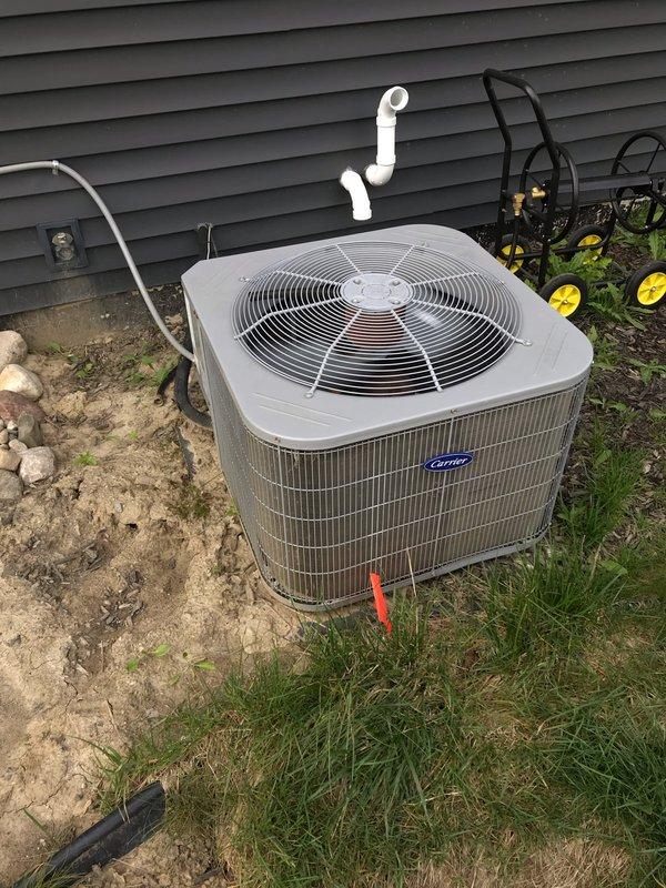 Completed preventive maintenance tune-up on Carrier air conditioning system and furnace. Inspected outdoor condenser unit, verified proper operation of compressor and condenser fan motor, checked electrical connections and capacitor function, and cleaned debris from interior cabinet. Evaluated tankless water heater for potential descaling flush service and provided membership program information to homeowner.