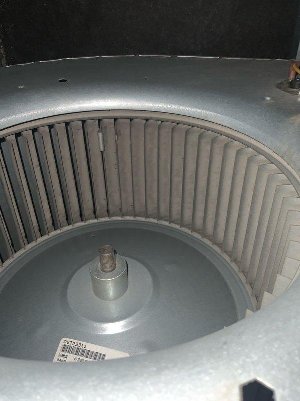 Responded to no-heat condition on tankless water heater unit. Upon inspection, accessed and evaluated the internal blower assembly and heat exchanger components. Examined the blower wheel housing and verified proper clearances of the centrifugal fan blades within the volute chamber. Documented equipment model number GMVM961005DXAA and serial number for service records. Inspected refrigerant lines, copper piping connections, and insulated tubing for proper installation and potential restrictions. Assessed the overall condition of the unit's internal components, noting normal wear patterns on metal surfaces. Unit was evaluated for operational readiness and proper airflow through the heat exchanger assembly.