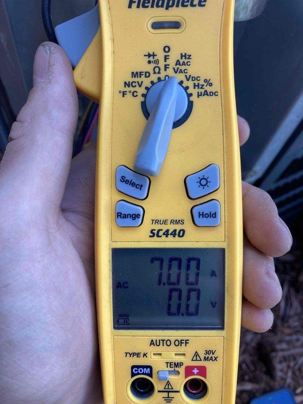 Completed preventive maintenance agreement visit for air conditioning system. Performed electrical diagnostics using digital multimeter, measuring amperage at 7.00A and voltage readings on contactor assembly. Inspected and verified proper operation of electrical contactor with multiple circuit connections, confirmed all wire terminations secure at brass terminal blocks, and documented system operating within normal parameters.