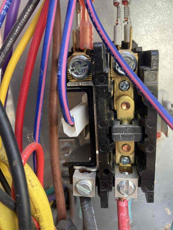 Completed preventive maintenance agreement visit for air conditioning system. Performed electrical diagnostics using digital multimeter, measuring amperage at 7.00A and voltage readings on contactor assembly. Inspected and verified proper operation of electrical contactor with multiple circuit connections, confirmed all wire terminations secure at brass terminal blocks, and documented system operating within normal parameters.
