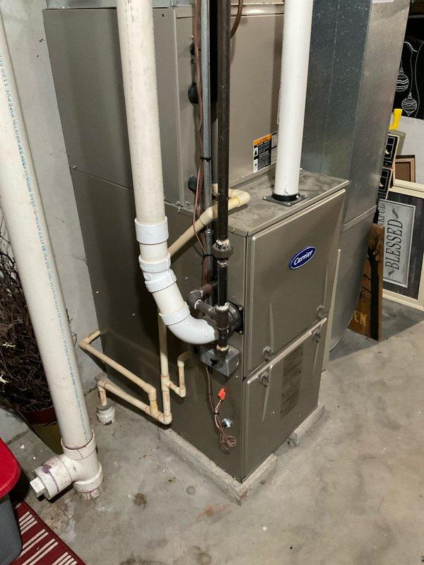 Conducted on-site evaluation of existing residential HVAC system to provide replacement estimate. Documented current Carrier furnace installation in basement utility area, including associated PVC venting, refrigerant lines, gas connections, and ductwork configuration. Recorded model and serial numbers from furnace and air conditioning unit nameplates for equipment specifications. Photographed electrical panel to assess current breaker capacity and availability for new equipment installation. Assessed existing infrastructure including venting, condensate drainage, gas supply line with shutoff valve, and refrigerant line routing to determine compatibility with replacement system options.