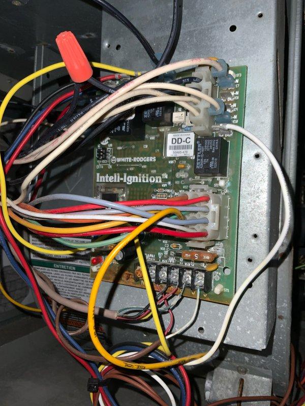 # HVAC Maintenance Visit - AC and Furnace System

Responded to service call for non-operational club AC and furnace system. Upon inspection, identified issues with the heating system's ignition control module and blower assembly. Examined the White-Rodgers Intell-Ignition control board and associated wiring connections within the furnace control panel. All wire connections were verified and secured, including multiple colored conductors (red, yellow, white, beige, and black) connected to the circuit board terminals.

Inspected the blower wheel assembly and noted significant corrosion on the central motor shaft, which required attention to prevent future operational failures. The blower wheel fins and housing were examined for proper clearance and debris accumulation. Performed necessary adjustments and repairs to restore full system functionality. Both cooling and heating systems were tested and confirmed operational upon completion of service. System returned to normal operation as pa