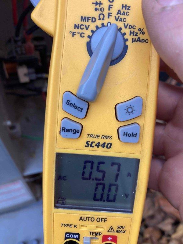 # HVAC Maintenance - Agreement Visit AC&SI Completed

Performed routine preventive maintenance inspection on air conditioning system under club membership agreement AC8-12. System operational assessment included electrical diagnostics using digital multimeter, which recorded 0.57 amp draw with normal voltage readings, indicating proper compressor and fan motor operation within manufacturer specifications.

During detailed inspection, identified significant corrosion and oxidation on electrical terminal block assembly at control panel. Heavy rust present on brass connector terminals and mounting hardware, creating potential safety hazard and risk of electrical failure. Corrosion concentrated around connection points where multiple circuit wires (yellow, red, and pink) interface with terminal block. This degradation likely caused by moisture intrusion or age-related deterioration in harsh operating environment.

Documented conditions with photographic evidence for maintenance records. Re