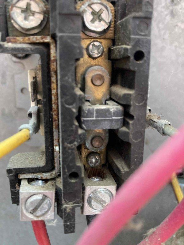# HVAC Maintenance - Agreement Visit AC&SI Completed

Performed routine preventive maintenance inspection on air conditioning system under club membership agreement AC8-12. System operational assessment included electrical diagnostics using digital multimeter, which recorded 0.57 amp draw with normal voltage readings, indicating proper compressor and fan motor operation within manufacturer specifications.

During detailed inspection, identified significant corrosion and oxidation on electrical terminal block assembly at control panel. Heavy rust present on brass connector terminals and mounting hardware, creating potential safety hazard and risk of electrical failure. Corrosion concentrated around connection points where multiple circuit wires (yellow, red, and pink) interface with terminal block. This degradation likely caused by moisture intrusion or age-related deterioration in harsh operating environment.

Documented conditions with photographic evidence for maintenance records. Re