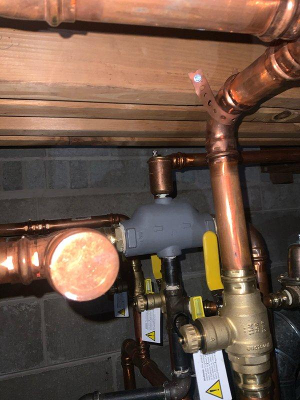 Completed preventive maintenance tune-up on residential hydronic heating system. Performed comprehensive inspection of boiler components, copper distribution piping, zone valves, expansion tank, and pressure relief valve. Verified proper operation of all yellow-handled gas shutoff valves, tested system pressures, checked for leaks at pipe joints and fittings, and confirmed adequate venting through black plastic flue assembly. All components found operating within manufacturer specifications with no deficiencies noted.