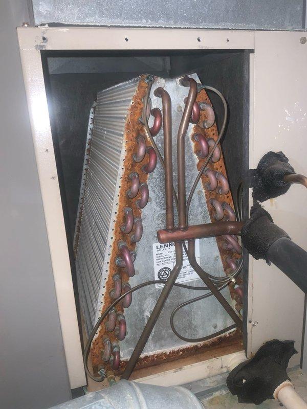 Completed preventative maintenance inspection on residential HVAC system under club AC8-12 agreement. Inspected and documented air handler unit, noting 14x25x1 air filter with moderate dust accumulation and visible dirt on unit base. Examined evaporator coil assembly and refrigerant line connections, observing significant rust and corrosion on copper refrigerant piping throughout U-bend sections, along with deteriorated foam insulation on refrigerant lines showing signs of age and wear requiring future attention.