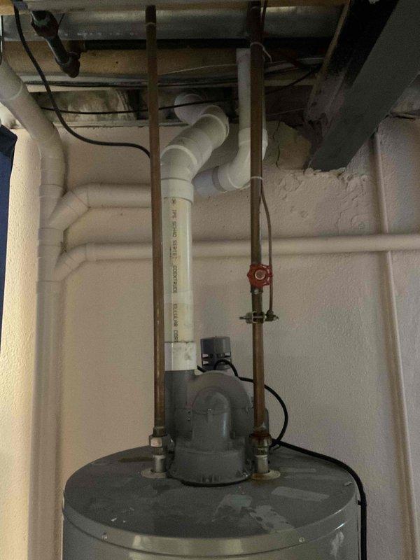 Conducted comprehensive assessment of existing Powerflex water heater installation in basement utility area for replacement estimate. Documented current unit specifications, connections including copper supply lines with shutoff valve, electrical service, and PVC venting system configuration. Evaluated surrounding infrastructure including spray foam insulation coverage, available clearances, and access for equipment removal and installation.