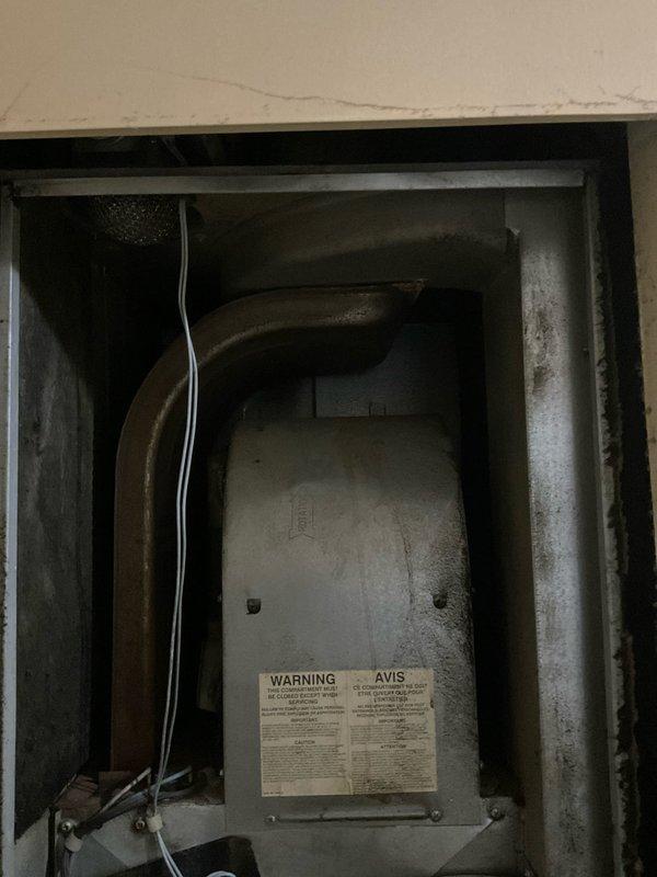 Conducted on-site assessment of existing mobile home furnace system to provide replacement estimate. Inspected furnace unit located in utility space, documenting current equipment condition including metal enclosure, ductwork configuration, and ventilation components showing age-related wear and dust accumulation. Evaluated electrical panel and circuit breaker arrangement to determine compatibility requirements for new furnace installation. Photographed existing equipment setup and electrical infrastructure to support accurate replacement specifications and material requirements for quote preparation.