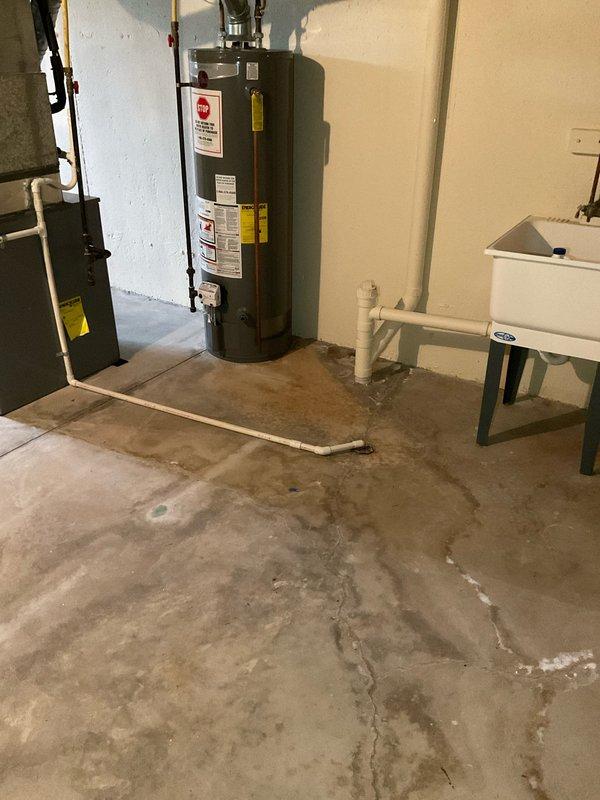 Conducted on-site evaluation for air conditioning system replacement estimate. Assessed existing Carrier HVAC equipment installation in basement utility area, documenting current system configuration including furnace/air handler unit, flexible ductwork connections, and rigid conduit routing. Photographed equipment condition and surrounding infrastructure to support replacement proposal specifications.