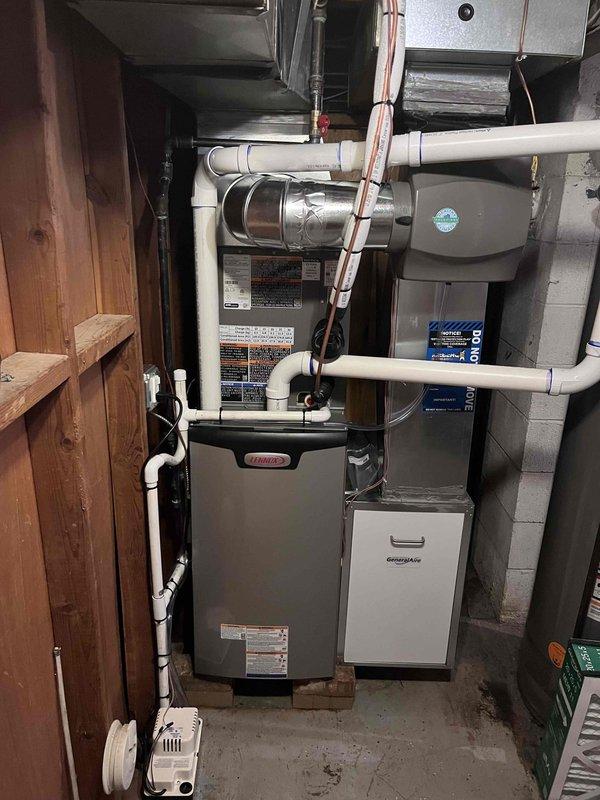 Completed full HVAC system installation including a 70,000 BTU Lennox furnace and 2-ton air conditioning unit with rear discharge configuration. Installation included all necessary mechanical and electrical connections, integration of humidifier system, and reconnection of existing components. System was pressure tested showing proper refrigerant charge at 127 PSI, with all copper refrigerant lines properly insulated and secured. Furnace was mounted on concrete blocks in basement location with complete PVC venting system installed, electrical panel connections completed, and all ductwork properly configured and sealed.