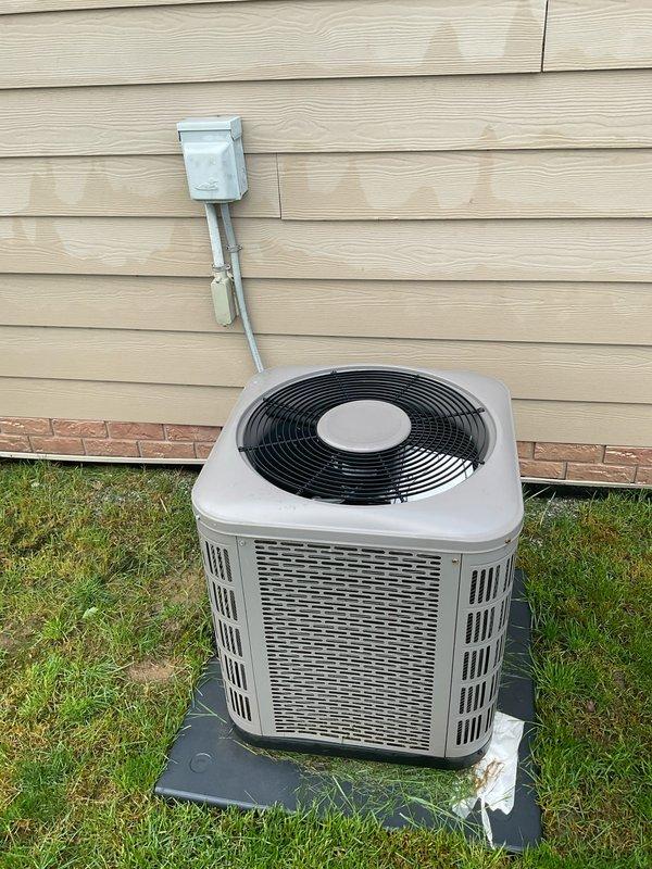 Conducted on-site evaluation for mobile home air conditioning system replacement. Inspected existing outdoor condensing unit, electrical disconnect box, and associated conduit connections. Unit currently positioned on concrete mounting pad with proper clearances from structure. Electrical disconnect properly mounted to exterior siding with metal conduit routing to equipment. Documented current system configuration including equipment placement, electrical connections, and site conditions through photographic documentation. Assessed installation requirements and provided comprehensive replacement estimate for single component HVAC system.