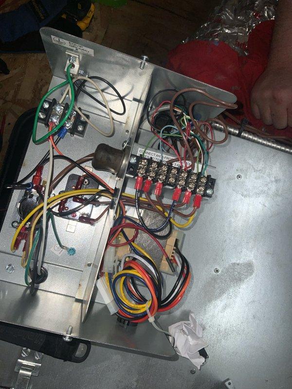 Responded to club maintenance call for non-operational compressor on residential AC unit. Accessed electrical control panel and inspected wiring connections, terminal blocks, and contactor assembly. Photographed internal electrical components showing multiple wire connections including power, control, and ground circuits for documentation and further diagnostic evaluation.