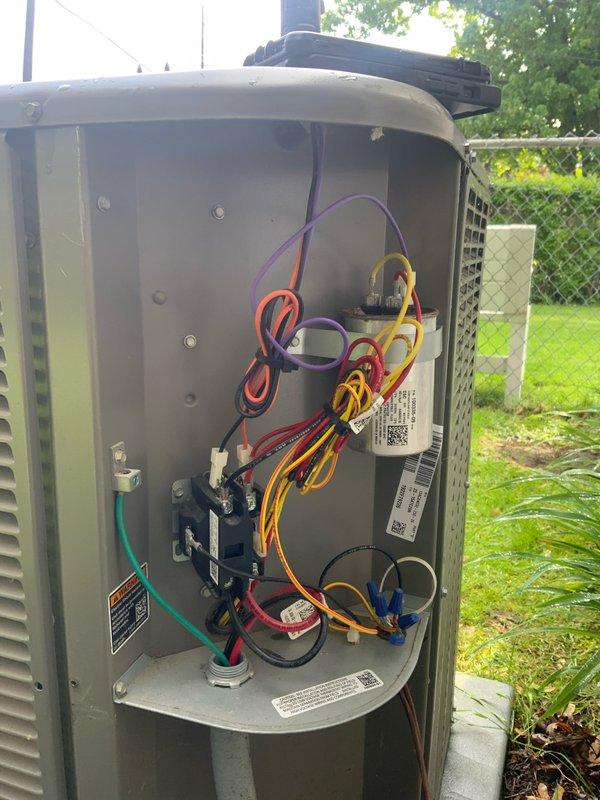 Responded to club maintenance call for non-operational compressor on residential AC unit. Accessed electrical control panel and inspected wiring connections, terminal blocks, and contactor assembly. Photographed internal electrical components showing multiple wire connections including power, control, and ground circuits for documentation and further diagnostic evaluation.