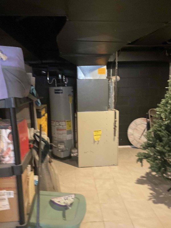 Conducted water heater replacement estimate at residential property. Assessed existing Envirotemp water heater installation in basement utility area, documenting current unit specifications, plumbing connections, and surrounding clearances. Evaluated installation space constraints, existing gas/water line configurations, and venting requirements. Photographed current equipment setup including water heater, furnace, and associated mechanical systems to provide accurate replacement proposal. Customer availability window accommodated between 3:30 PM and 6:00 PM for consultation and estimate review.