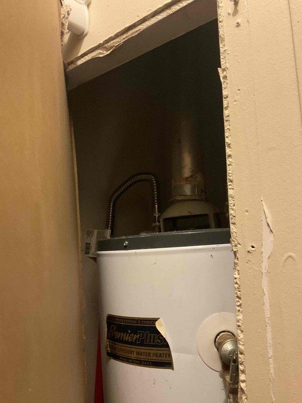 Completed on-site assessment for water heater replacement in residential property where occupant has been without hot water for approximately one month. Evaluated existing ComfortMaster energy water heater installed in recessed wall alcove, documented current plumbing connections including flexible supply lines and metal piping at top of unit, and assessed HVAC system integration with return air vent and equipment cabinet. Provided detailed estimate for replacement unit with availability projected within 4-6 weeks, and discussed financing options to facilitate installation.