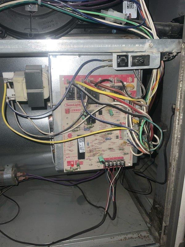 Responded to customer complaint of thumping noise coming from HVAC unit. Performed diagnostic inspection of blower assembly and electrical control components. Accessed blower wheel and squirrel cage fan to identify source of mechanical noise. Inspected blower wheel for debris, imbalance, and proper mounting on motor shaft. Examined SureLight control board and associated electrical connections for any loose components or wiring issues that could contribute to abnormal operation. Documented condition of blower assembly showing dust accumulation and normal wear patterns on interior components.
