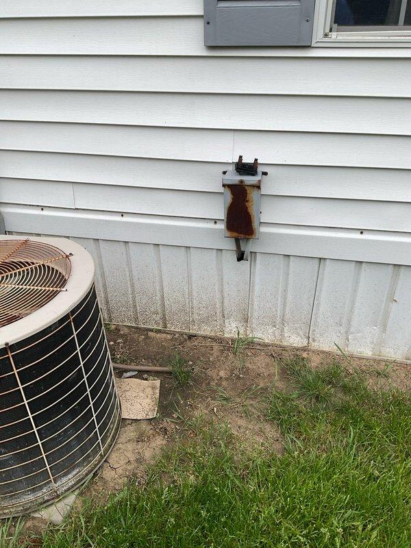 Provided estimate for complete HVAC system replacement at residential property. Evaluated existing indoor air handler unit located in narrow utility closet with minimal clearance, and assessed outdoor condensing unit with severely corroded accumulator/filter drier component exhibiting extensive rust damage on exterior siding. Documented current system configuration and condition through photographs showing compromised refrigerant line components requiring replacement. Prepared comprehensive quote for 8-10 ton cooling capacity system upgrade to address failing equipment and restore proper climate control functionality.
