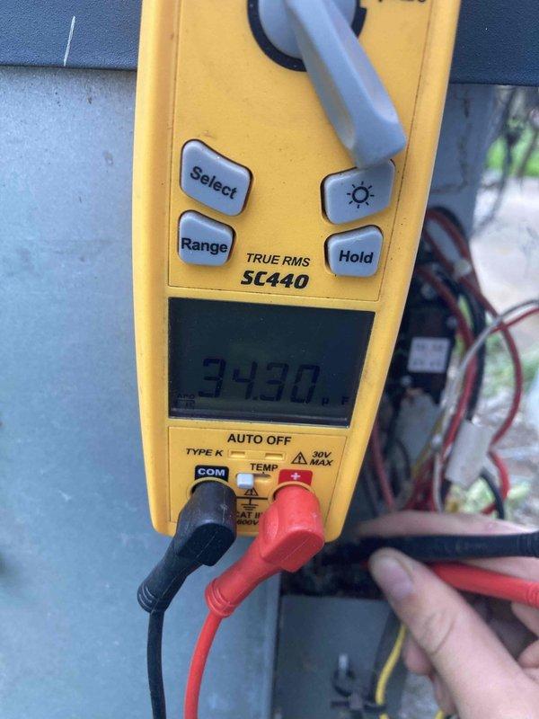 Completed preventive maintenance tune-up on air conditioning system. Performed diagnostic testing using digital multimeter to verify electrical readings at 343V and checked system parameters with handheld gauge displaying normal operating conditions. All measurements confirmed unit operating within manufacturer specifications.