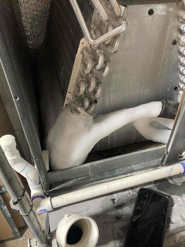 Responded to no cooling complaint on residential HVAC system. Upon inspection, accessed blower assembly and evaporator coil compartment to diagnose airflow and cooling issues. Examined blower wheel for debris accumulation, proper alignment, and operational condition. Inspected evaporator coil configuration and condensate drainage system including PVC piping and connections to ensure proper function and drainage flow. Verified all mechanical components were secure and operational, completing diagnostic assessment of the cooling system.