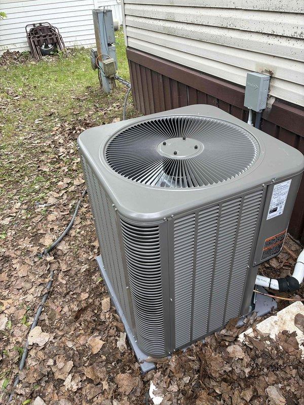 Completed full installation of 3-ton air conditioning system with matching evaporator coil in rear yard location. Unit positioned on ground pad with proper clearances, electrical disconnect installed and wired to meet code requirements, refrigerant lines connected and tested, condensate drainage established with PVC piping routed to appropriate discharge point. System pressurized, leak tested, evacuated, and charged to manufacturer specifications. Verified proper airflow, temperature differential, and electrical parameters. All mechanical and electrical connections secured and operational.