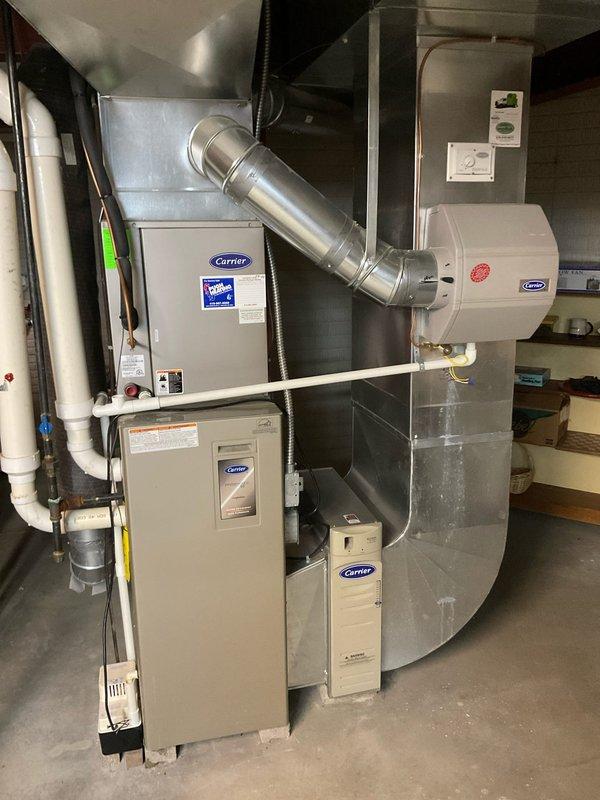 Provided comprehensive HVAC system replacement estimate for residential property, evaluating existing Carrier equipment including furnace, air handler, humidifier, and filtration components. Assessed current system configuration with metal ductwork, PVC drainage lines, and integrated air quality equipment for potential upgrade to more efficient equipment. Customer informed of available utility rebate program for air conditioning system upgrade to improve energy efficiency and system performance.