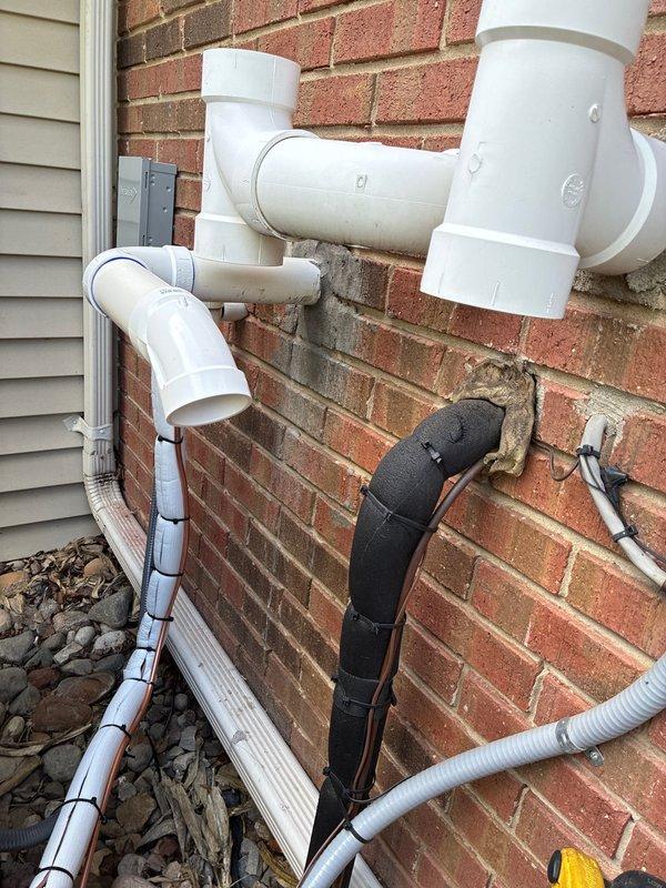 Completed installation of 3-ton air conditioning system with matching evaporator coil in left-side configuration. System was evacuated to proper vacuum levels as verified by digital gauge readings, refrigerant lines were reconnected and charged, and condensate drainage system was routed externally along building exterior with appropriate PVC piping and insulated line sets secured to structure.