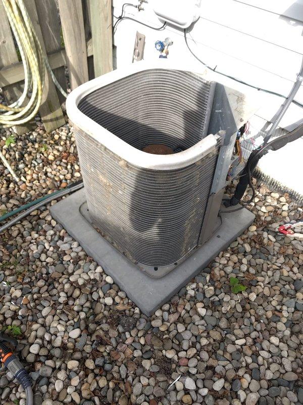 Completed routine maintenance inspection on residential air conditioning system under club membership agreement. Performed visual inspection of outdoor condenser unit, documenting equipment condition including heat exchanger coils, compressor housing, and refrigerant line connections. Unit operational with normal wear patterns observed on exterior components and minor debris accumulation noted on internal mounting surfaces.