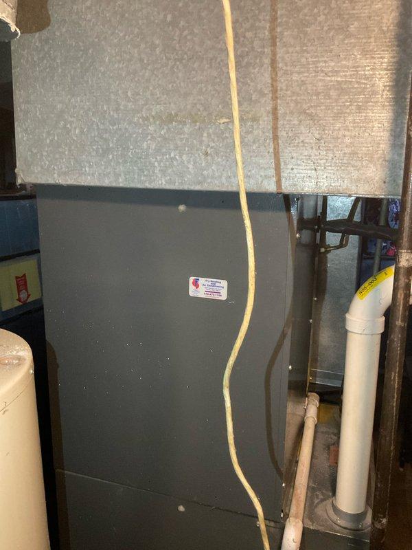 Responded to service call for 20-year-old R22 air conditioning system found completely flat on refrigerant. Upon arrival, assessed Goodman CAPF037C2A central cooling unit installed in basement with air handler. Documented existing equipment condition through photographs showing model and serial number specifications, refrigerant type, and current installation configuration including ductwork and condensate drain routing. Provided comprehensive replacement estimate for air conditioning system only per homeowner request, as furnace was recently serviced by their preferred contractor. System age and obsolete R22 refrigerant make replacement most viable option versus repair.
