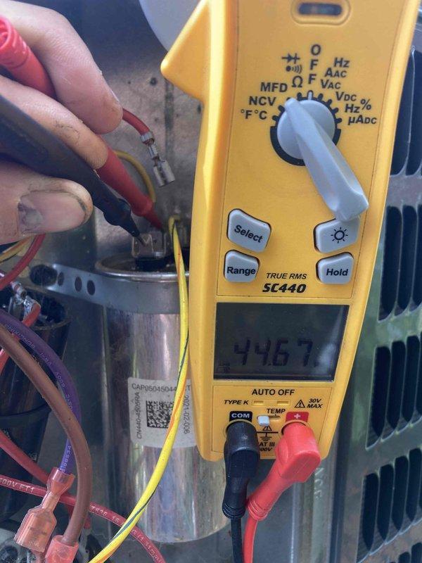 Completed AC Club 12-4 preventive maintenance agreement visit on residential air conditioning system. Performed comprehensive electrical diagnostics using digital multimeter, measuring voltage readings on capacitor terminals which displayed 456V and 446.7V respectively, confirming proper electrical operation within manufacturer specifications. Inspected all electrical connections, wiring harness, and capacitor condition as part of seasonal inspection protocol.