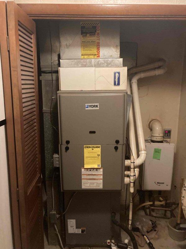 Completed preventative maintenance inspection on York TWB080C16MP1114A forced air furnace system as part of Club AC12-4 agreement visit. Performed comprehensive system evaluation including visual inspection of all accessible components, verified manufacturer specifications and clearances, documented equipment model and serial number information, and captured photographic records of installation conditions in basement mechanical room. All equipment found operating within normal parameters with proper venting configuration and adequate clearances to combustibles maintained.