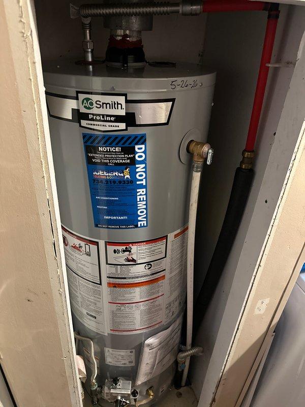 Completed installation of A.O. Smith ProLine commercial-grade tanked water heater in residential utility closet. Installed new unit with proper plumbing connections including hot and cold water lines, pressure relief valve with discharge piping, and flexible connector hoses at top of tank. Secured all copper and brass fittings at base and top of unit per manufacturer specifications. Ensured proper venting through ceiling penetration with PVC pipe, sealed with expanding foam insulation and metal escutcheon plate. Verified all safety labels, warranty information, and manufacturer specifications are visible and intact on unit. Reconnected all water supply lines and tested system for proper operation and leak-free connections. Installation completed with all code-compliant materials and methods.