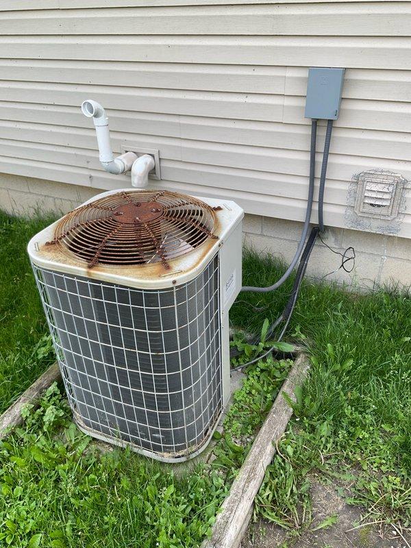 Completed comprehensive HVAC system evaluation for furnace replacement and upstairs heating/cooling options. Documented existing outdoor condensing unit showing significant rust deterioration on top surface and assessed overall system condition including electrical disconnect, refrigerant lines, and drainage components. Provided multiple equipment replacement estimates with various configuration options to address current system deficiencies and improve climate control for upper level of residence.