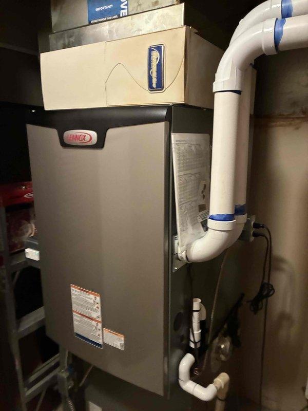 Completed installation of a 90,000 BTU Lennox furnace system in residential basement utility area. Connected all necessary PVC venting, condensate drainage lines, gas supply, and electrical connections per manufacturer specifications and local building codes. System tested and verified operational with all safety controls functioning properly.