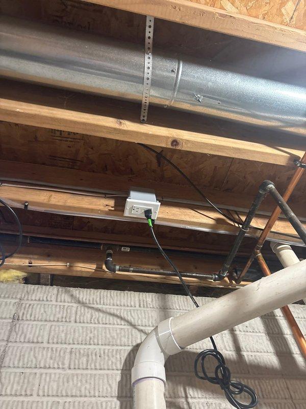 Installed dedicated 120V electrical circuit for power-vent water heater in basement utility area. Ran new electrical wiring from main panel through exposed ceiling joists to water heater location, securing cable properly along structural members. Mounted weatherproof electrical box and installed GFCI-protected outlet adjacent to water heater to provide power for exhaust blower motor. Verified proper grounding, tested circuit functionality, and confirmed adequate clearances per manufacturer specifications and local electrical code requirements.